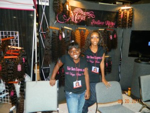 "Maya" banner and hexagon shaped hang tags (background). Plus womens t-shirts on display at Bronner Bros. Hair Show, Atlanta